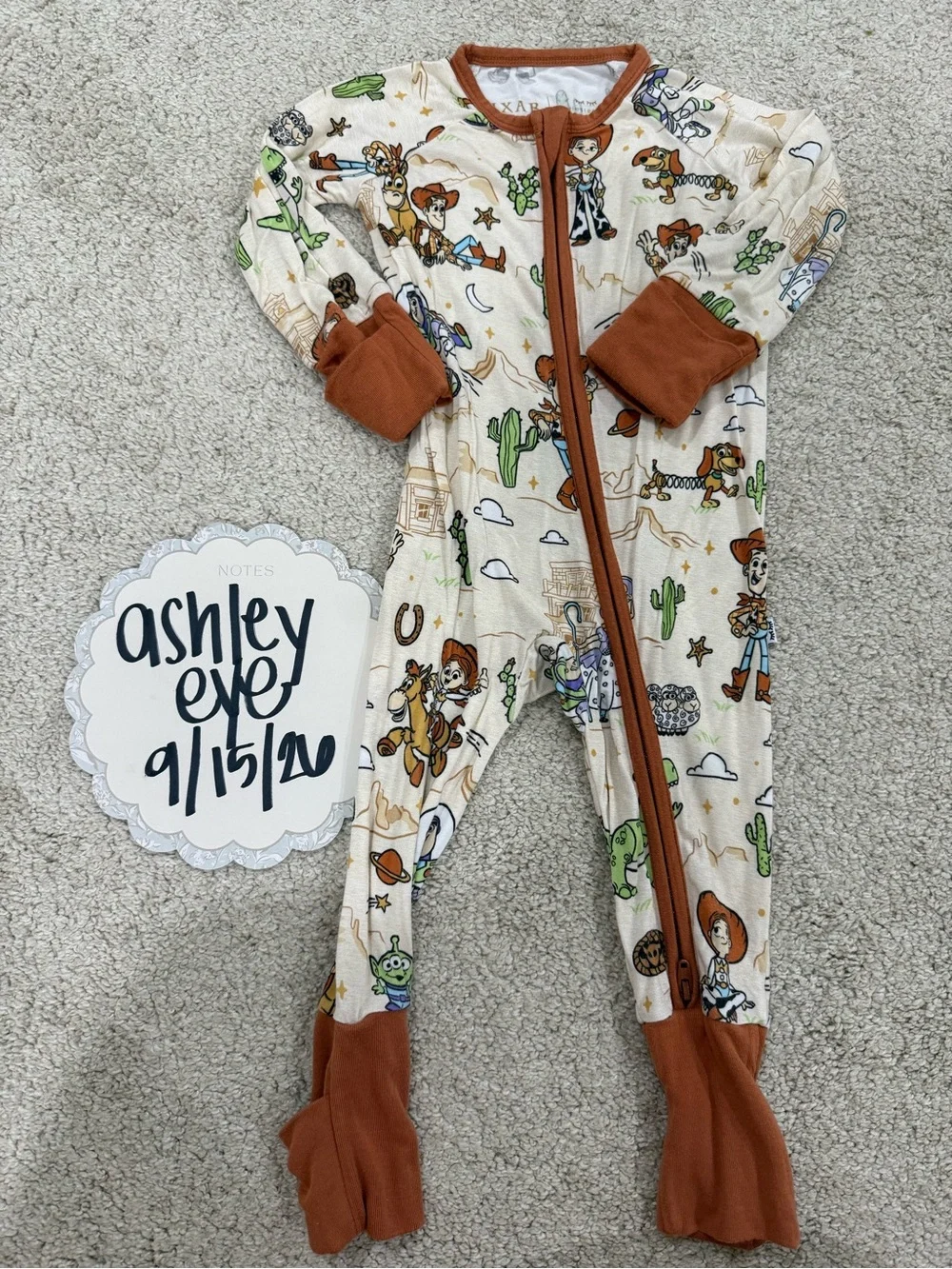 Little Sleepies Cream Toy Story Footed One-Piece Pajamas with Brown Trim